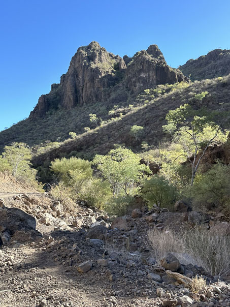 Alluvial hillside and rock outcrops with lots of greenery